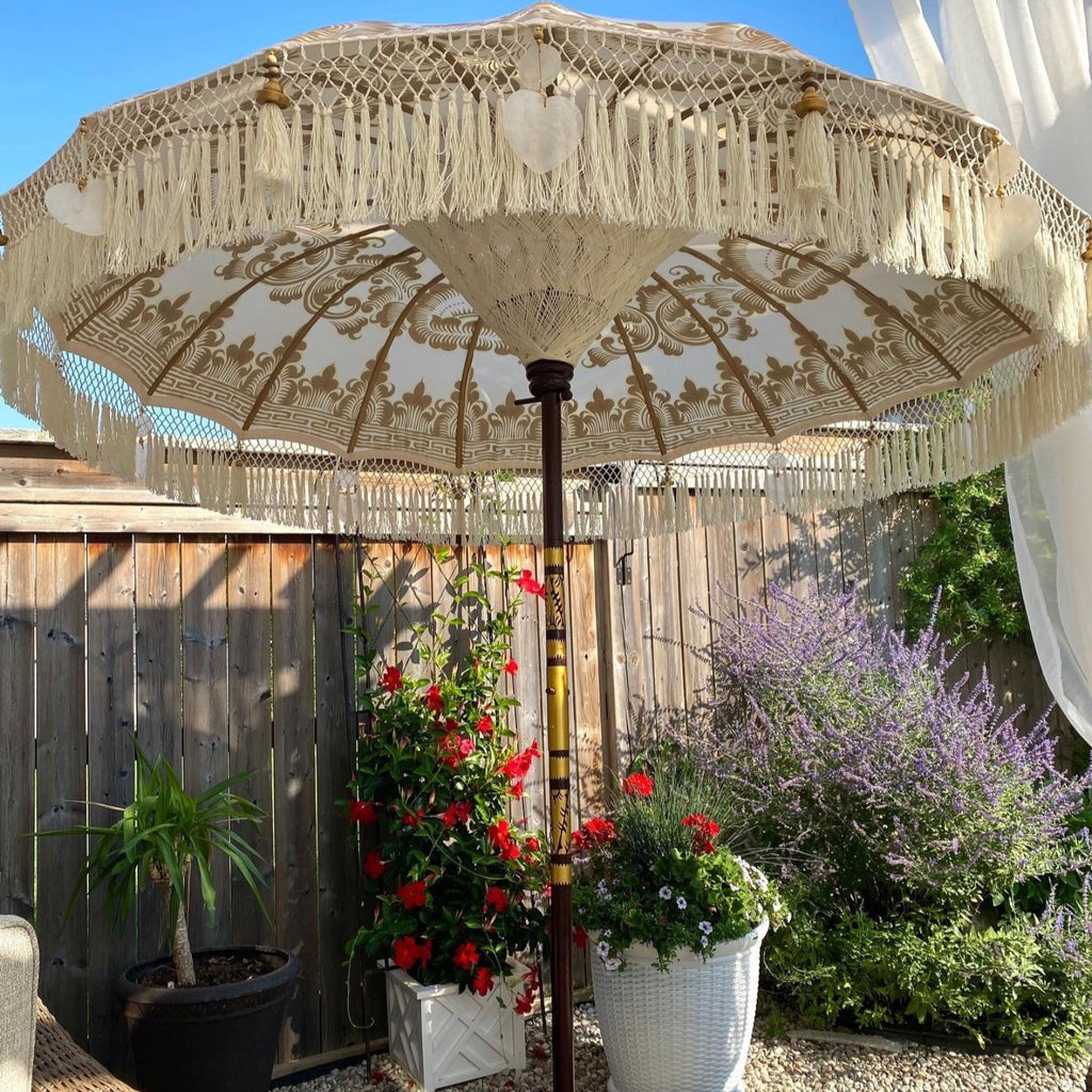 Golden Abbey umbrella enhancing a vibrant outdoor garden with classic charm.