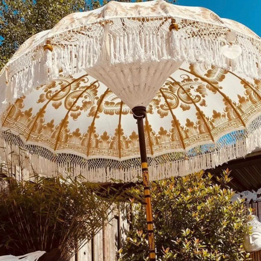 Golden Abbey umbrella with intricate gold details and fringe design.