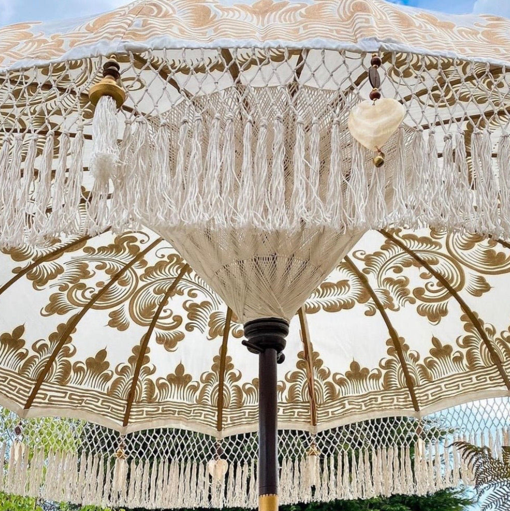 Close look to the Bohemian-style Golden Abbey umbrella creating a cozy and elegant outdoor ambiance.