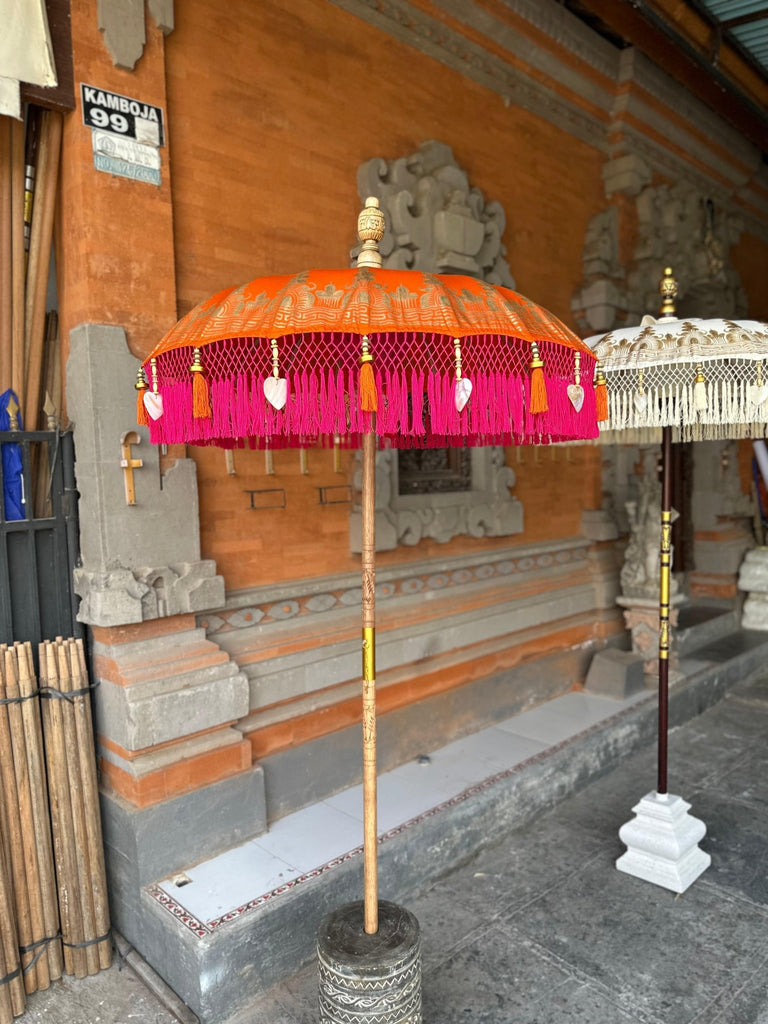 Clementine Parasol standing elegantly against a traditional Balinese backdrop, blending culture and vibrant design.