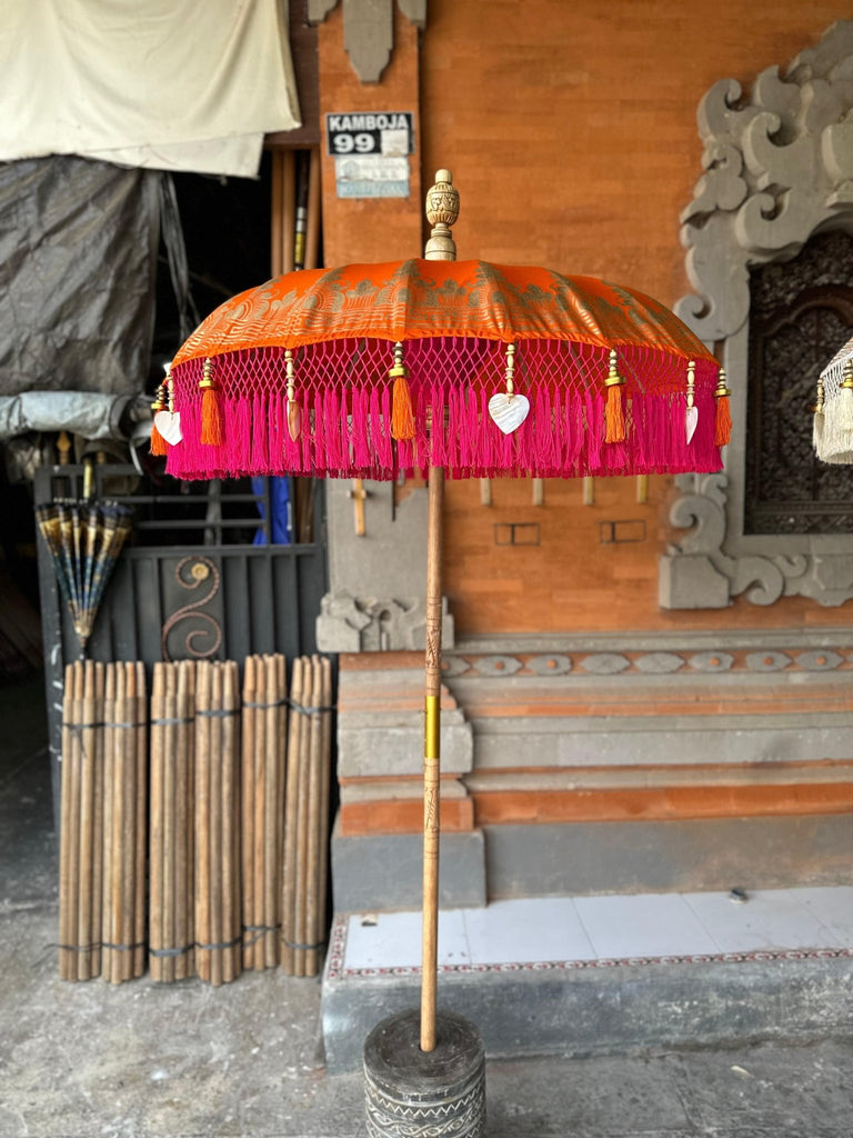 Elegant view of the Clementine Parasol with vibrant orange and pink tones, perfect for brightening up any outdoor space.
