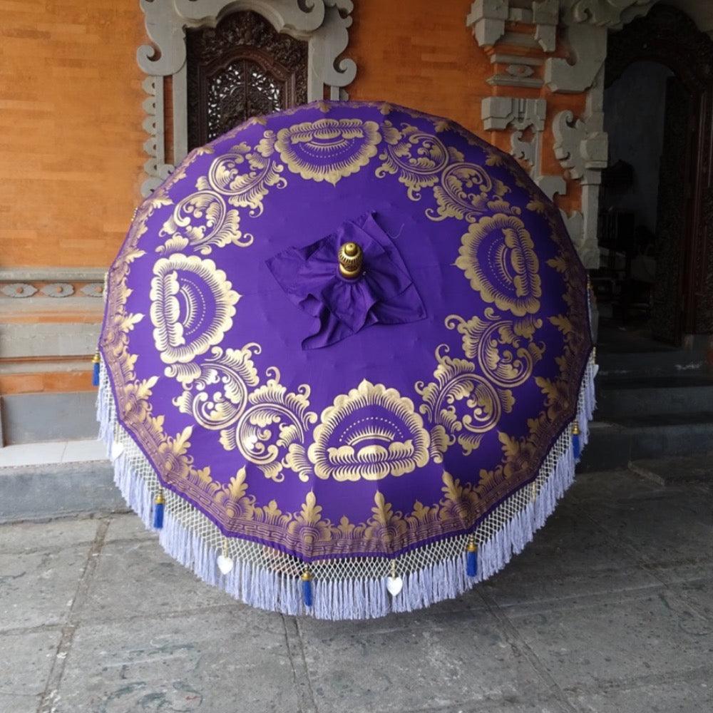 Elegant Claudia Balinese Parasol with gold hand-painted details on a rich purple canvas.