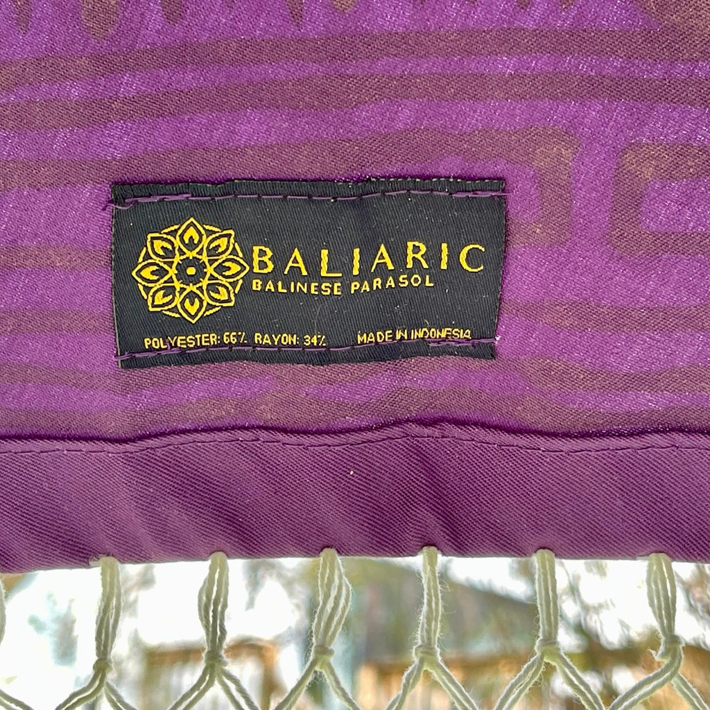 Claudia Balinese Parasol adding a luxurious touch to a lush backyard setting.