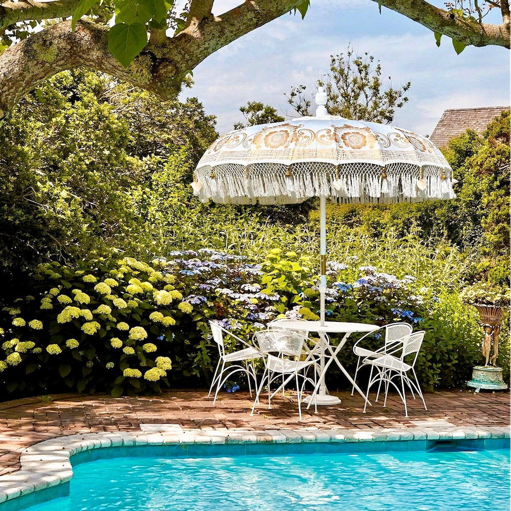 Elegant Ally Parasol with white canvas, gold accents, and a carved wooden pole—ideal for gardens and terraces.